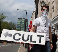 cult sign held by protester in london