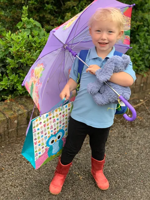 Child with an umbrella and gift bag