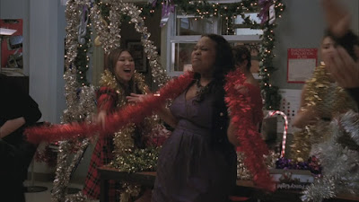Mercedes being wrapped in garland by Tina and other glee members
