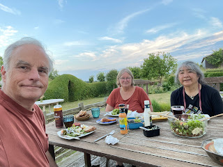 Salmon, fishcakes, rolls, salad and drinks on Lotte's patio