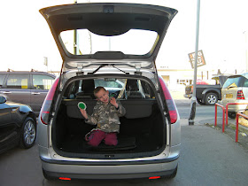 boy in boot of car