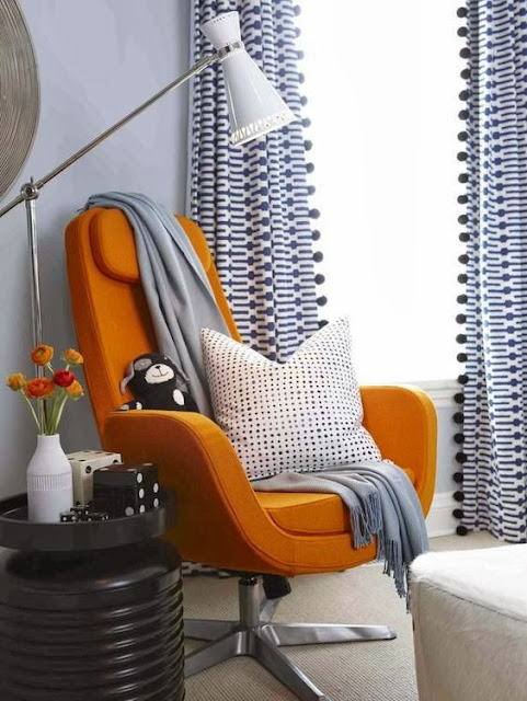 Pumpkin orange modern chair and blue curtains - Fall decor inspiration