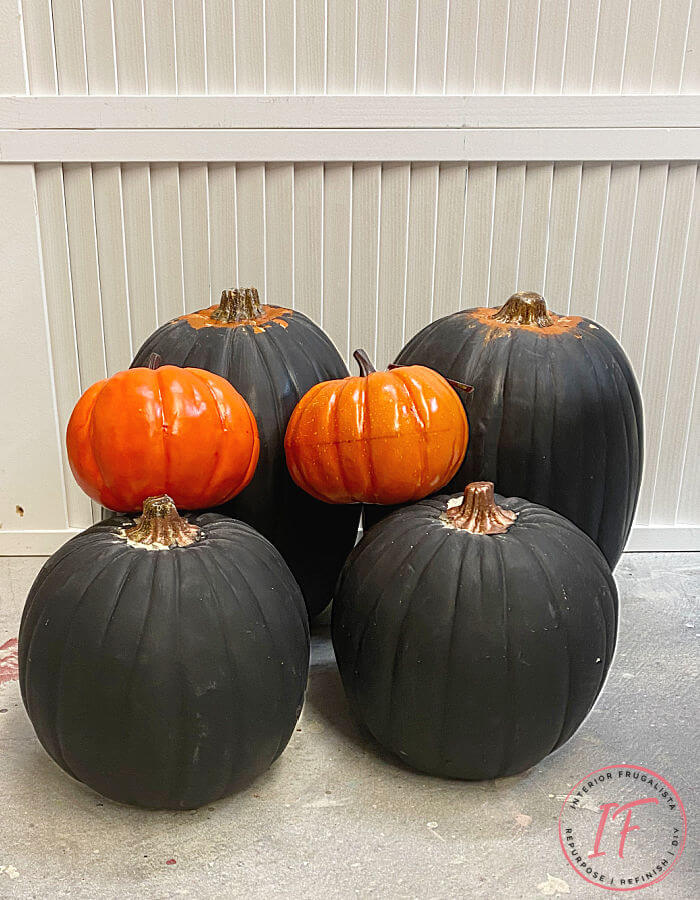 Unique Rust Paint Dripped Abstract Pumpkin Topiaries with white artificial stacked pumpkins and rust activated paint to decorate outdoors for fall.