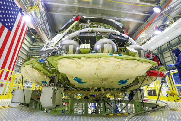 The CST-100 Starliner capsule that will fly on Orbital Flight Test-2 later this year undergoes assembly inside the Commercial Crew and Cargo Processing Facility...at NASA's Kennedy Space Center in Florida this month.