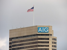 AIG signage and flag atop office tower on Allen Parkway