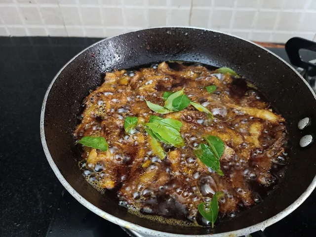 Flavorful Curry Leaves Infusing Crispy Kozhuva Varuthathu - A Spicy South Indian Anchovies Fry