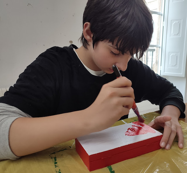 Alumno decorando caja de madera