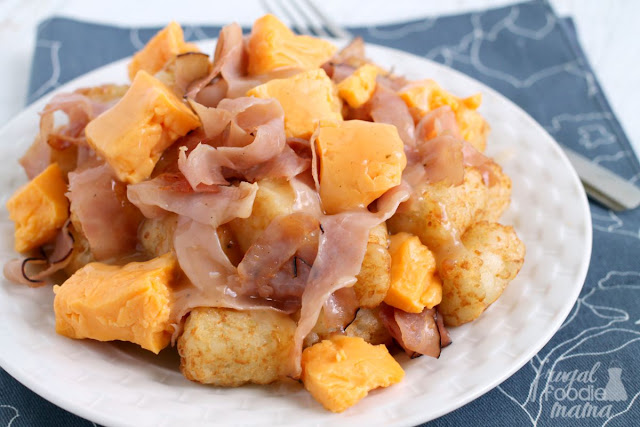 Fresh cheese curds and ham are served over top of crispy tater tots and then smothered in a turkey gravy in this easy to make Ham & Cheese Tater Tot Poutine.