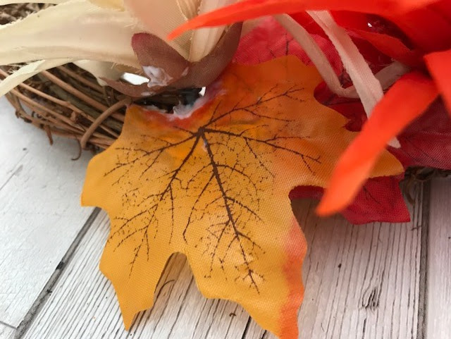 Leaves being glued around the flowers