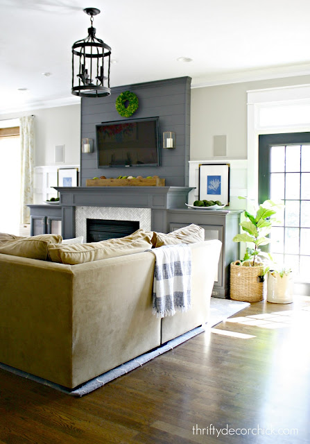 Dark gray fireplace with marble surround