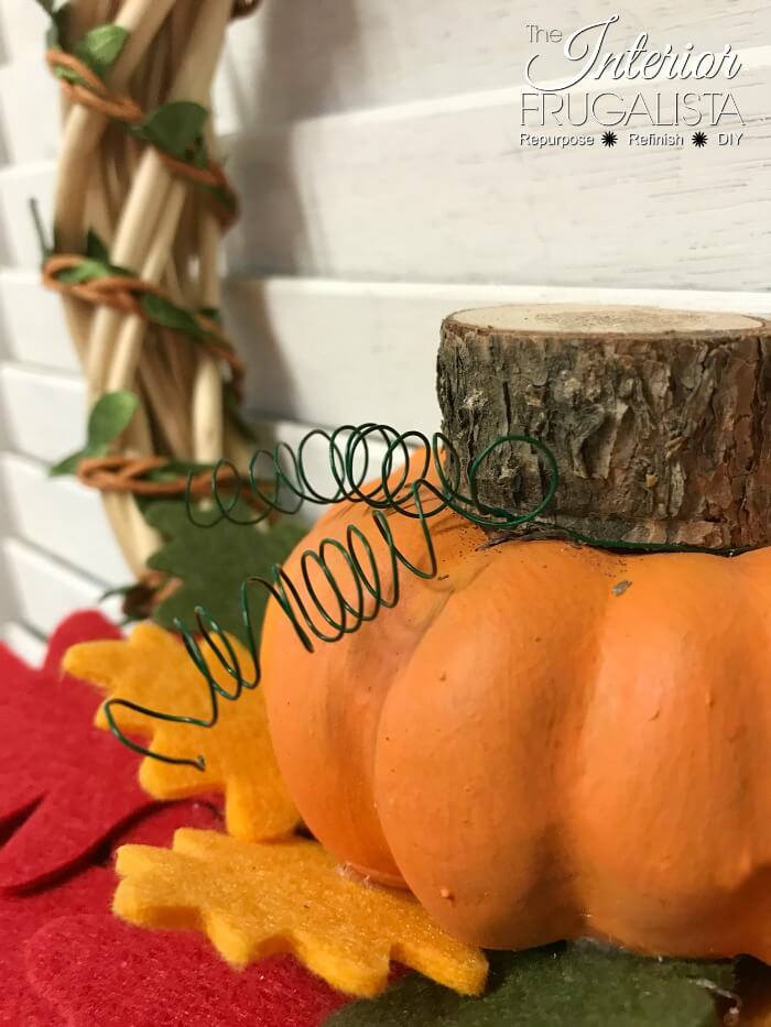 Turn inexpensive dollar store finds into an adorable small DIY Fall Pumpkin Wreath and it's so quick and easy to make in five minutes or less.