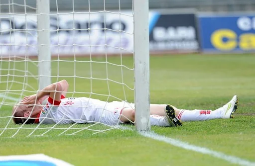 Bari defender Andrea Masiello reacts after scoring an own goal against Lecce