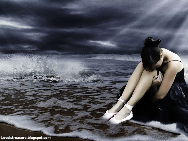 sad girl sitting alone near coast