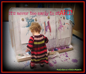 photo of: "It's Never too Early to Start Art" Young Child at Easel Painting 