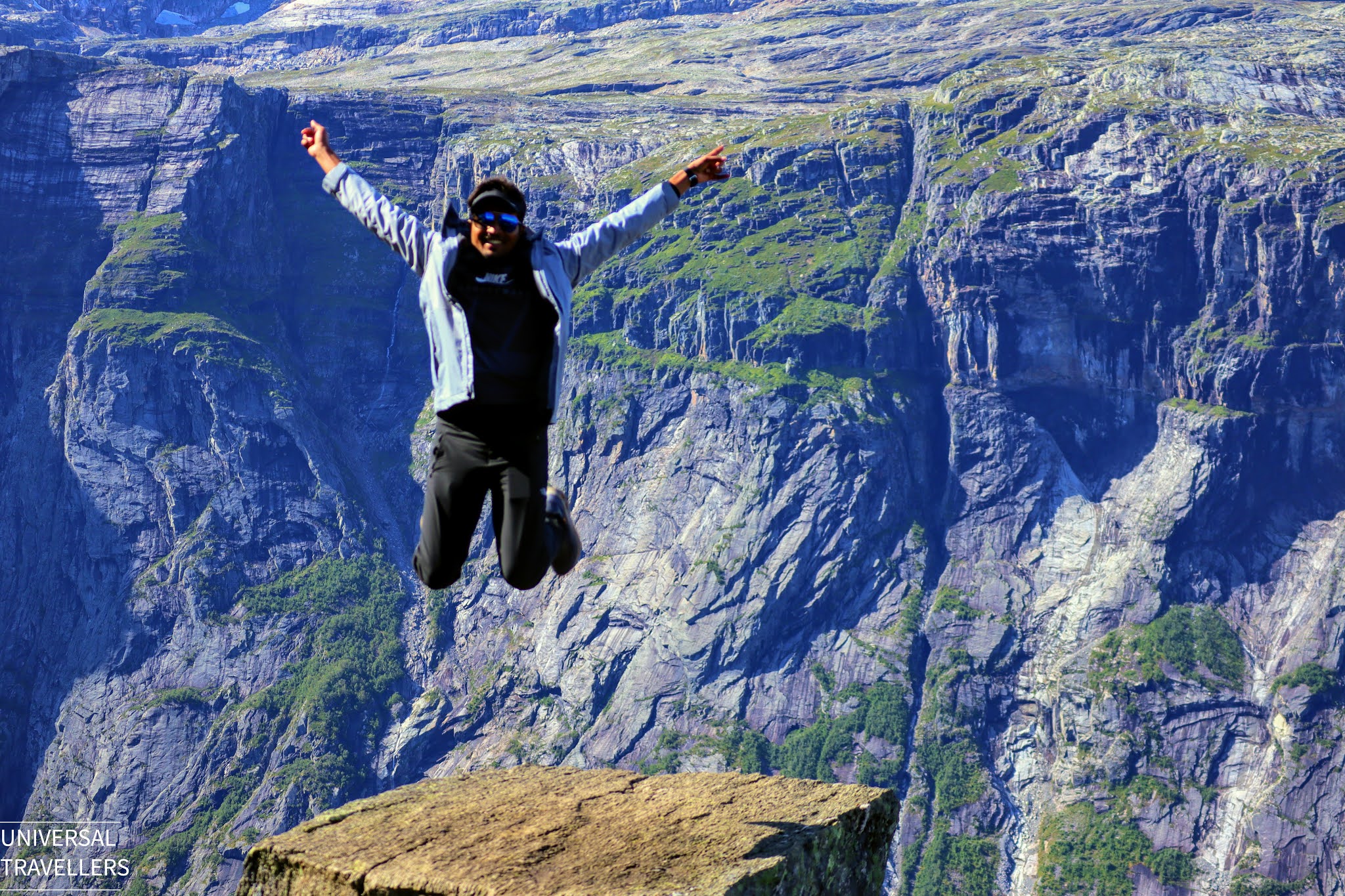 A boy is posing at the top of the Trolltunga