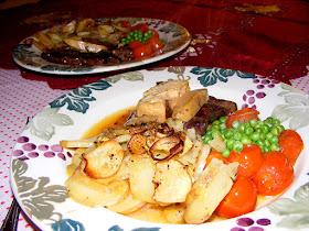 Flashed beef flank steak topped with foie gras served with roasted cherry tomatoes, peas and pommes boulangere. Cooked and photographed by Susan from Loire Valley Time Travel. https://tourtheloire.com