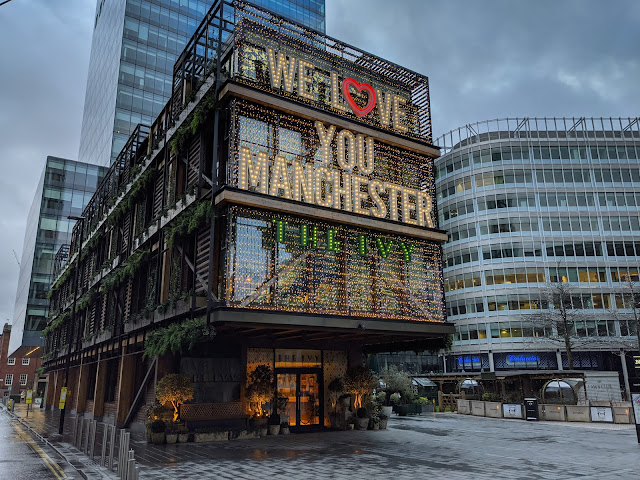 Modern building with text We Love You Manchester