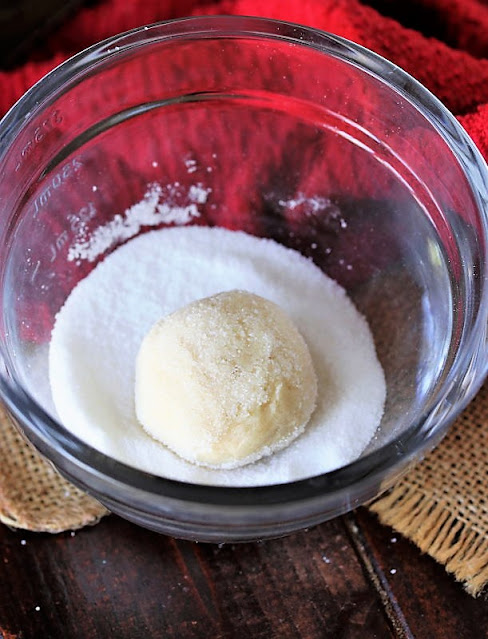 Rolling Chewy Sugar Cookie Dough Ball in Granulated Sugar Image