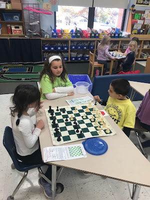 third grader helping with chess