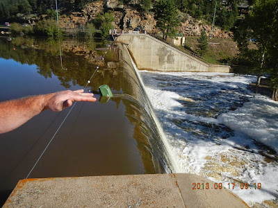 Photo: Normal safe operation of a dam with water flowing past the dam through the defined spillway structure.