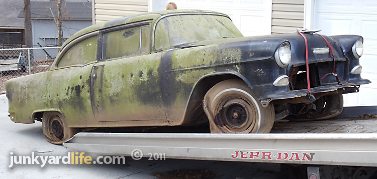 The 1955 Chevy slid not so much rolled off the flatbed wrecker