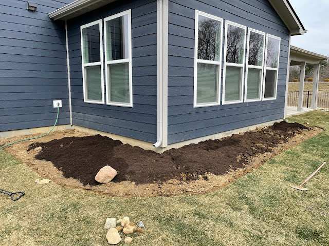 adding topsoil to new landscaping bed