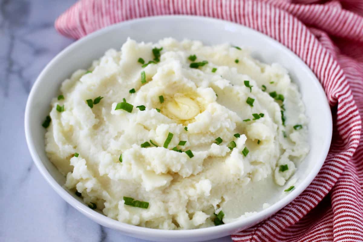 Creamy Garlic Mashed Potatoes in a white bowl.