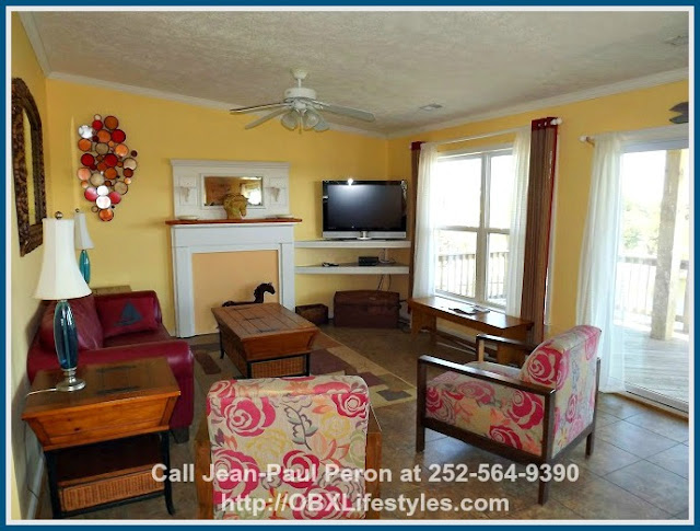 The living room of this stunning canal front home for sale in Corolla NC has a light and airy ambience that you'll love.