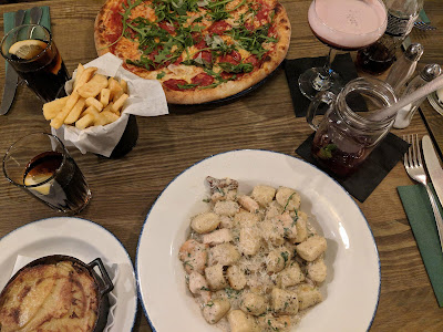 flatlay style image of pizza chips and gnocchi on a wooden table