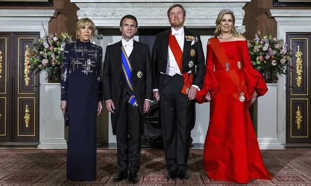 Queen Maxima wore a new red satin dress by Claes Iversen. President Emmanuel Macron and Brigitte Macron