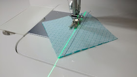 Using a sewing machine laser to sew half square triangles