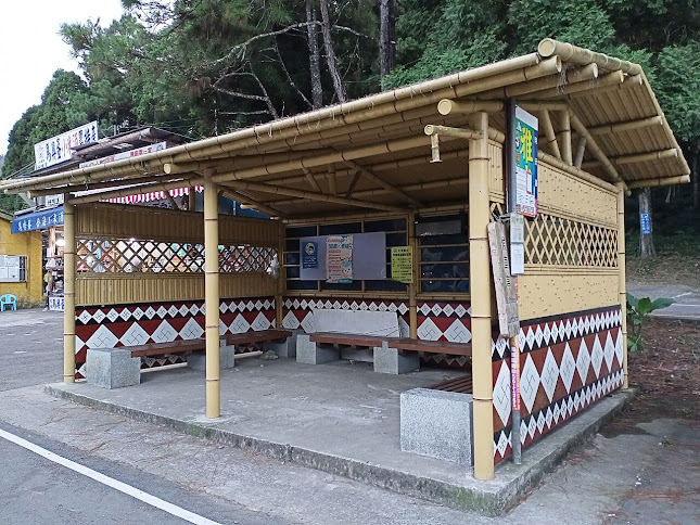 Wooden bus shelter with a large amount of rotated swastikas within diamonds.