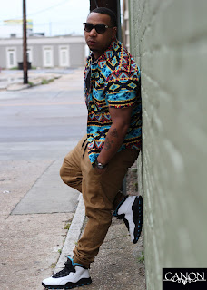 Young Canon leaning against a wall wearing Jordans