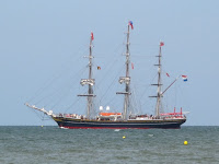 A tall ship leaves port