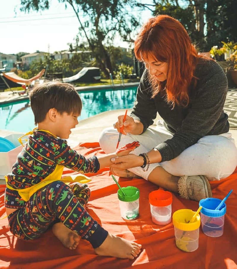 toddler painting with their hands