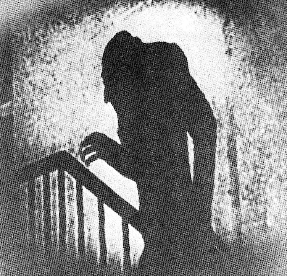 1910s Nosferatu profile in shadow climbing stairs
