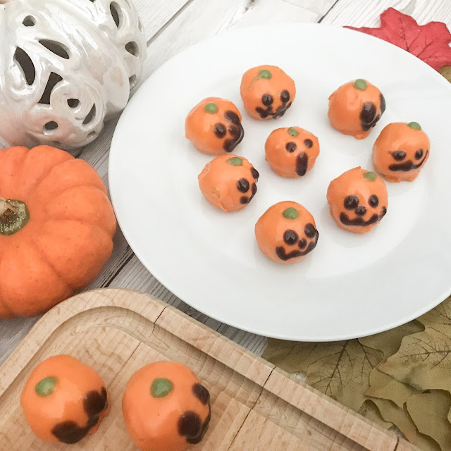 Picture of plated pumpkin bites surrounded by real and ornament pumpkins