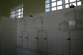 Open-Bay Showers in a prison offer hot and cold water faucets, unlike the first NTCC Bathhouses that for years had no hot water!