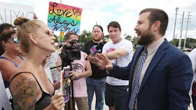 Reverend Steven Anderson confronts protestors in Florida at a 'Make America Straight Again' event. The preacher's online videos caught the eye of a B.C. man who has been forbidden from teaching Anderson's extreme religious views to his children. (The Associated Press)
