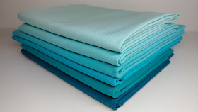 Kona solid fabrics in aqua and turquoise