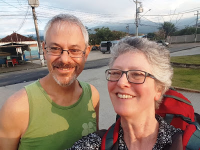 T and me at the bus station with a backdrop of mountains