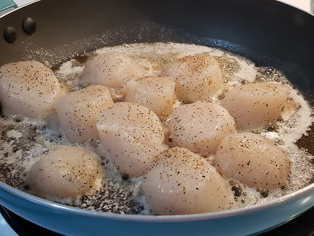 Scallops cooking in grease