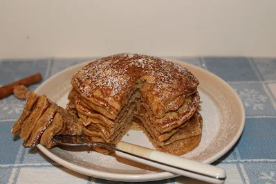 Cutting into a stack of spelt eggnog pancakes.