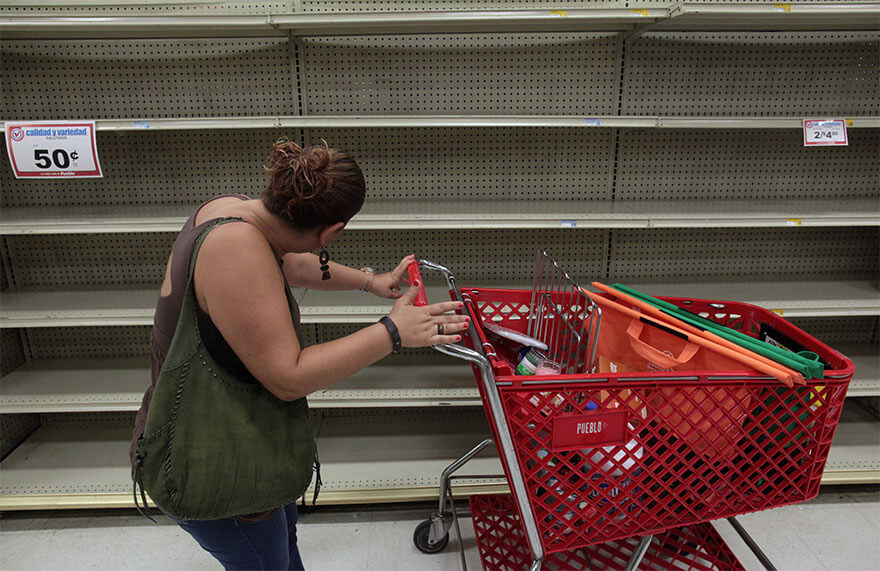 30 Shocking Pictures That Show How Catastrophic Hurricane Irma Is - A Woman Looks At Empty Shelves That Are Normally Filled With Bottles Of Water