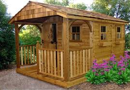  wood frame shed having a hinged roof to provide space for housing