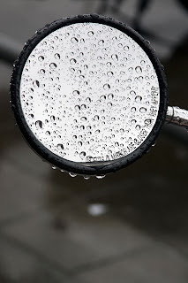 mirror of motorbike with raindrops