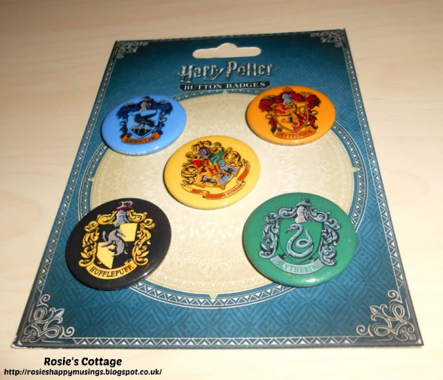 Rosie's Latest Huge Harry Potter Haul - A set of five badges showing the crests of Hogwarts and all four houses.