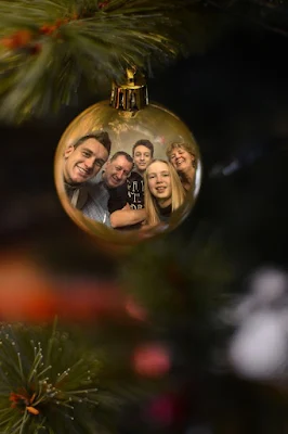 Reflexos em Ornamentos:  Que tal fotografar o reflexo da família ou amigos em bolas de Natal? Uma maneira única de capturar momentos especiais.