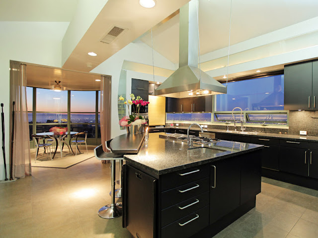 Photo of incredible modern kitchen with triangle shaped kitchen island in the middle