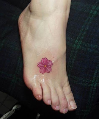 A small flower tattoo design on the foot perfect for girls wanting a taste